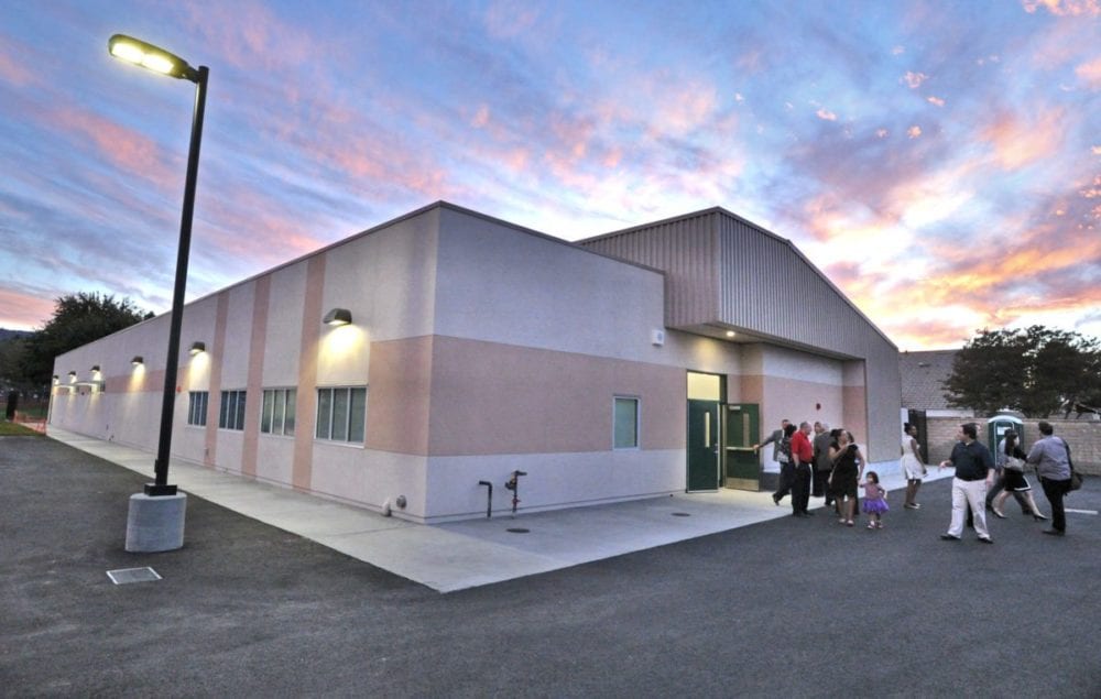 Students, parents and dignitaries tour the special education building at the school after the official ceremony for the opening of two new permanent modular buildings at Old Orchard Elementary School in Newhall on Monday. Dan Watson/The Signal