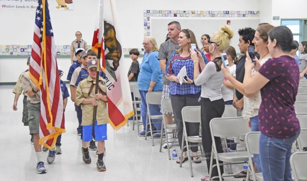 Cub Scouts from Troops 608 of Newhall carry the colors to open the official ceremony for the opening of two new permanent modular buildings at Old Orchard Elementary School in Newhall on Monday. Dan Watson/The Signal
