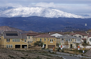 Snow covers the hills north of Santa Clarita, overlooking the Five Knolls development, as seen from Ermine Street at Golden Valley Road on Monday morning. Katharine Lotze/Signal